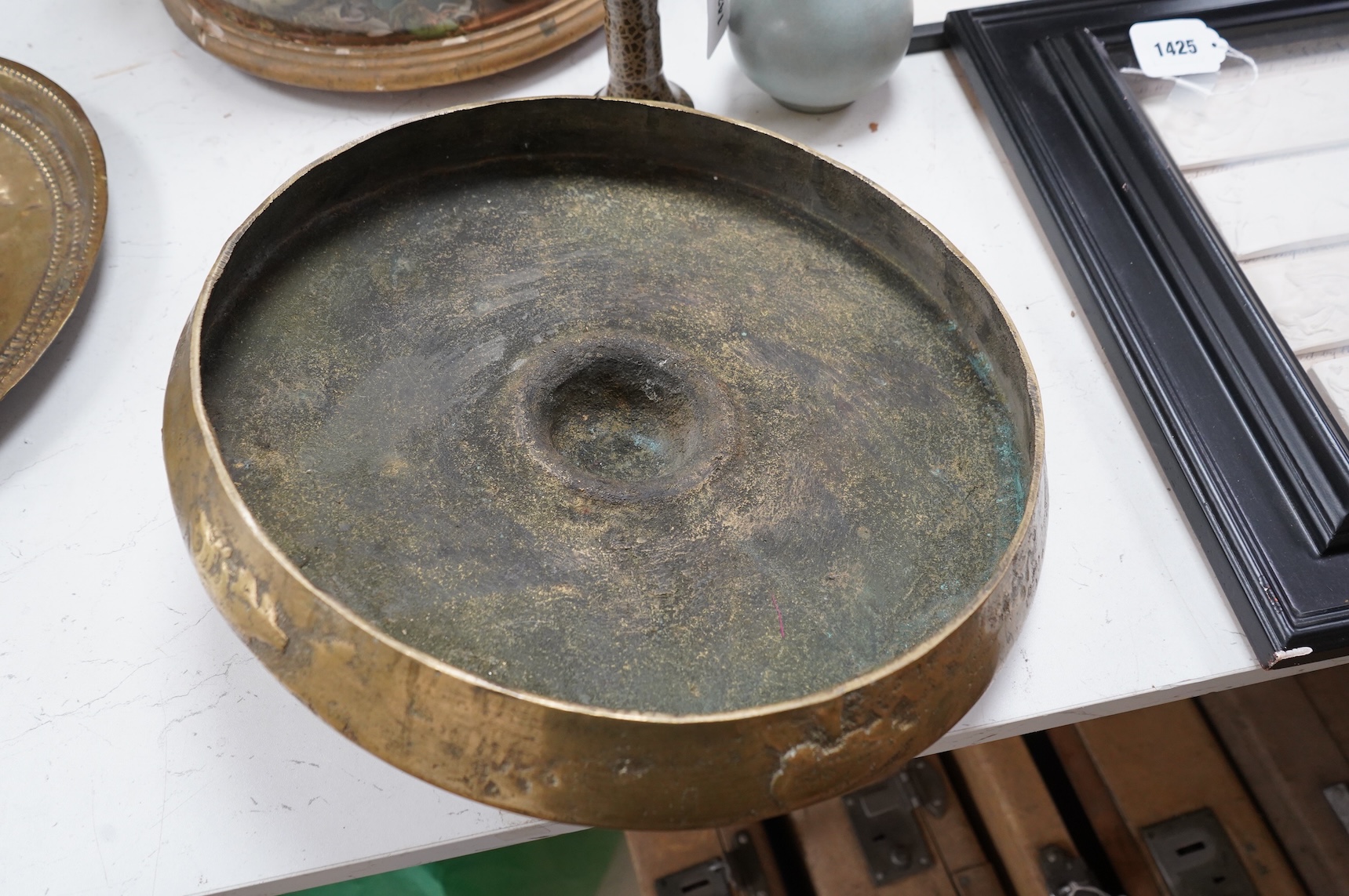 A Brunei bronze temple gong, decorated in relief with a three clawed dragon, 38cm in diameter